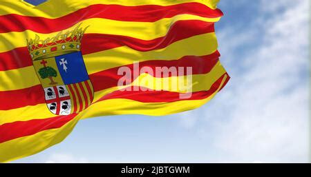 Aragonese flag waving in the wind on a clear day. Aragon is an ...