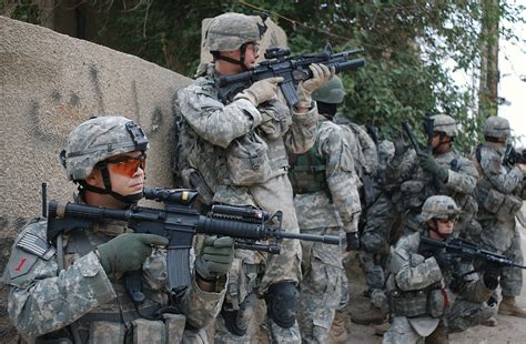 Staff Sgt. John Gregory leads a dismounted patrol of 1st ID troops ...