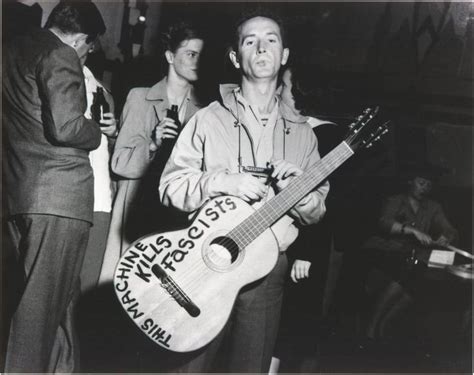 Woody Guthrie with his guitar (1941) | Folk musician, Famous guitars ...