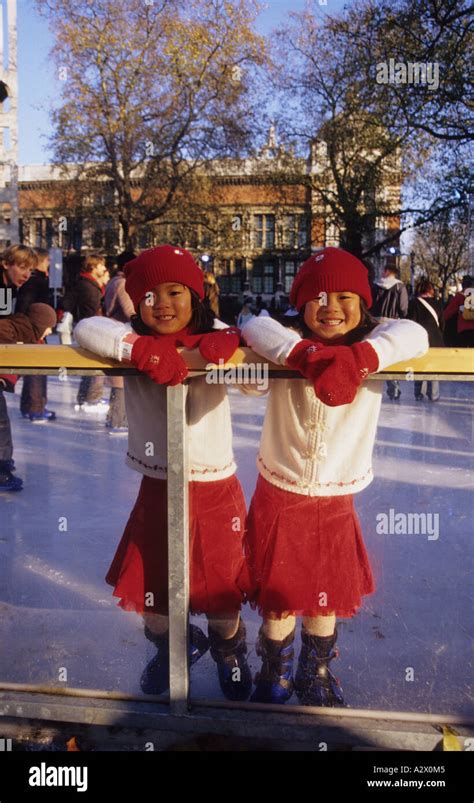 Chinese twins ice skating at the Natural History Museum in London Stock Photo - Alamy