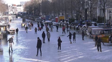 Ice skating fun at frozen canal in Amsterdam - YouTube