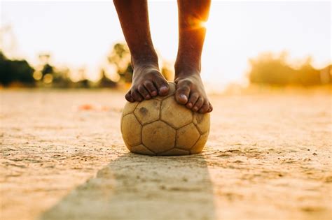 Premium Photo | Kids playing soccer football for exercise with bare foot