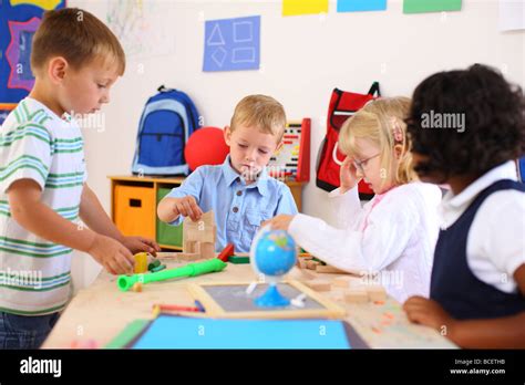 Four kids playing in preschool classroom Stock Photo, Royalty Free ...