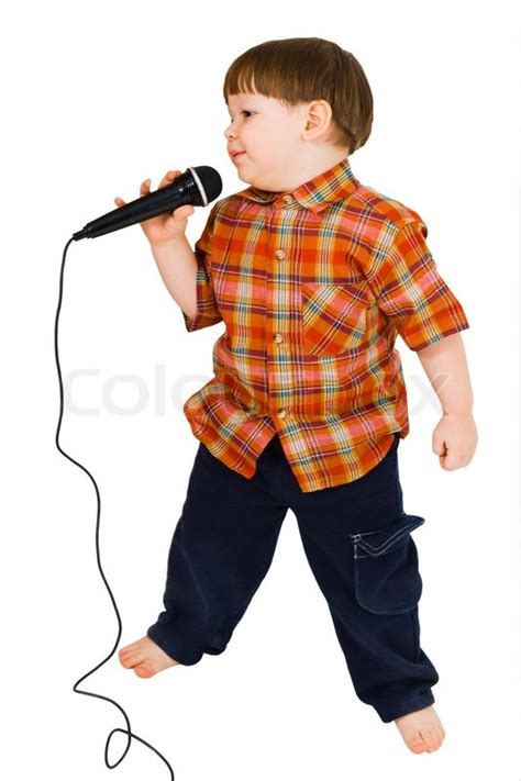 Kid singing, with black microphone on ... | Stock image | Colourbox