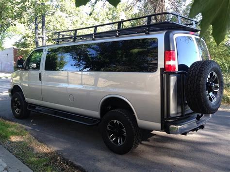 Chevy GMC van with Aluminess tire rack, roof rack and ladder. Photo cred: Advanced 4x4 Van | Van ...