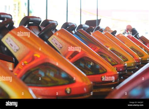 Lineup of orange dodgem bumper cars seen at a funfair in Barry, Wales, UK Stock Photo - Alamy