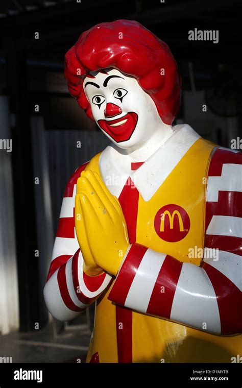 Statue of Ronald McDonald of McDonalds restaurant making traditional Thai greeting Sawasdee in ...