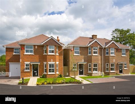 New housing development. One detached house and two semi-detached houses Stock Photo - Alamy