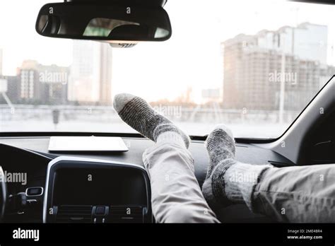 Man with feet on dashboard in car Stock Photo - Alamy