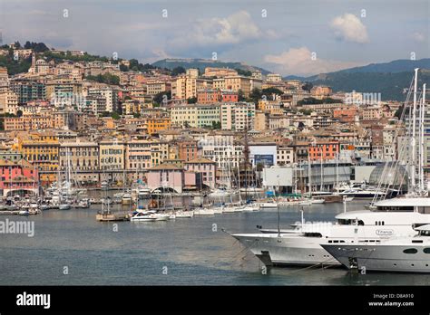 Genoa port, Italy, dockside view looking inland, typical Genoa houses. Private yachts in ...