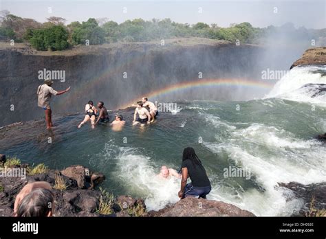 Victoria Falls, Zambia side, people on an adventure holiday swimming ...