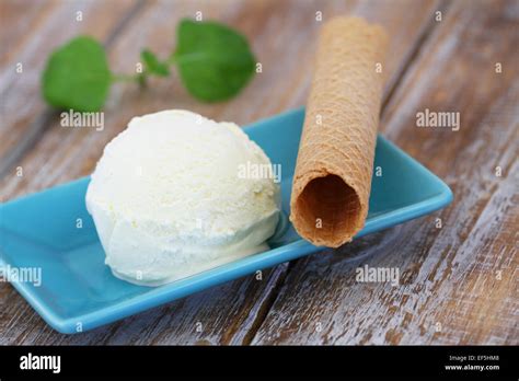 Vanilla ice cream and wafer on rustic wooden surface Stock Photo - Alamy