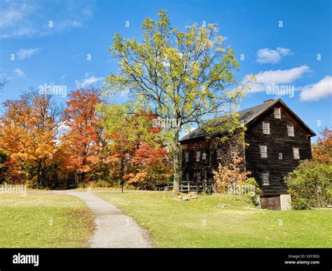 Classic Fall scene, an old mill at surrounded by colourful Autumn ...