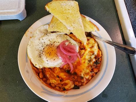 Cheesy beans with toast and a fried egg : PutAnEggOnIt