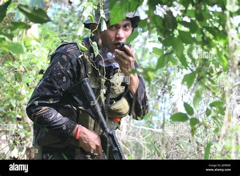 A Philippine Soldier, 1st Scout Ranger Regiment, along with U.S. service members, conducts fire ...