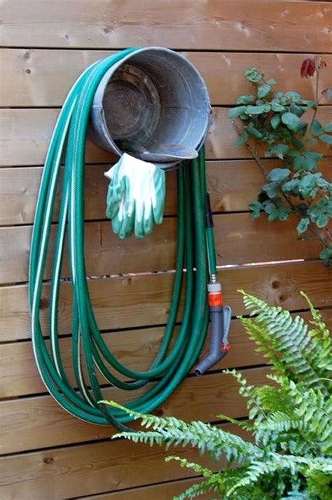 19 Ways to Organize Your Garage on a Budget | Garden hose holder, Hose holder, Garden hose