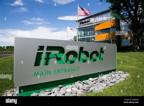 A logo sign outside of the headquarters of the iRobot Corporation in ...