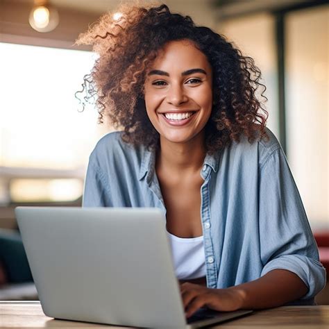 Premium AI Image | a woman is smiling while using a laptop.