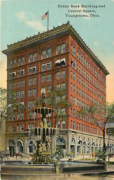 an old postcard shows the building with fountain in front and american flag on top