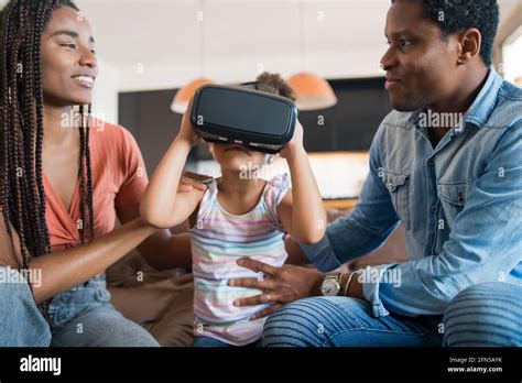 Family playing video games with VR glasses Stock Photo - Alamy