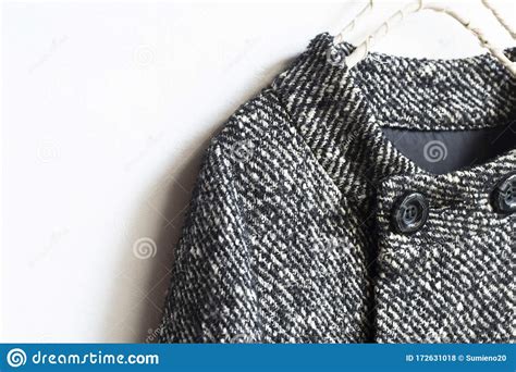 Black and White Wool Coat Hanging on Clothes Hanger on White Background Stock Photo - Image of ...