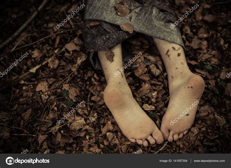 Dead body feet in leaves Stock Photo by ©jhandersen 141057304