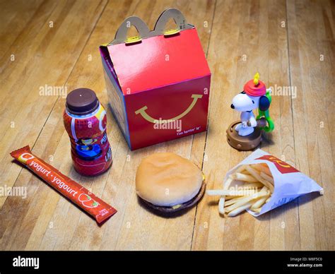 A McDonald's Happy Meal with a cheeseburger, French fries, chocolate ...