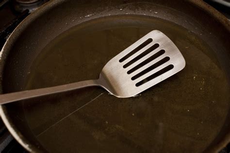 Clean non-stick frying pan with metal spatula - Free Stock Image
