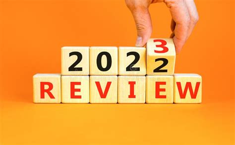 2023 Review New Year Symbol. Businessman Turns a Wooden Cube and Changes Words Review 2022 To ...