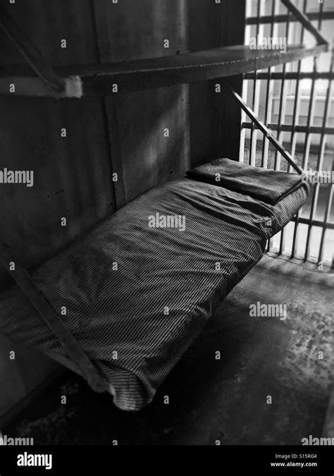 A bed in an old jail cell Stock Photo - Alamy