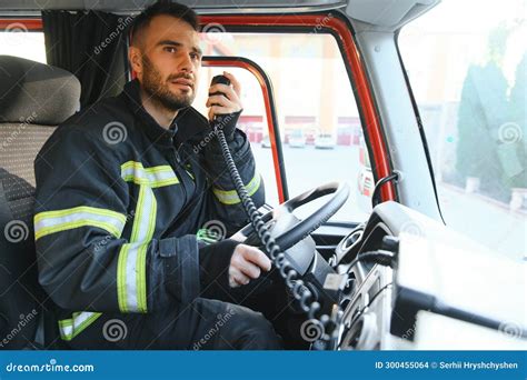 Firefighter Using Radio Set while Driving Fire Truck Stock Photo - Image of male, fire: 300455064