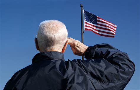 View of a veteran saluting the flag of the United States. - military ...