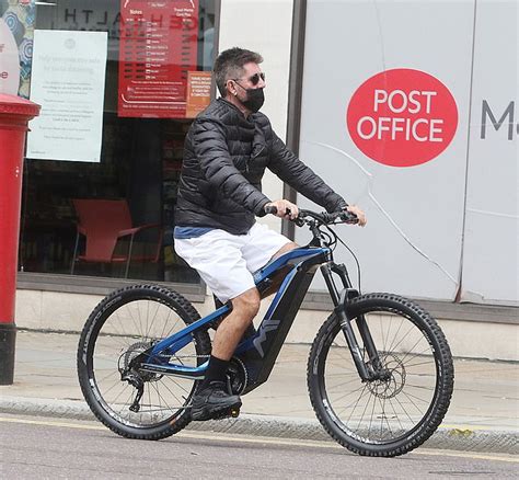 Simon Cowell narrowly misses another bike disaster as he cycles wrong direction up one-way ...