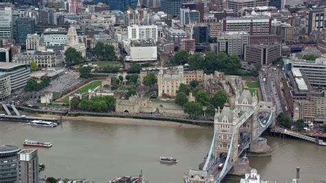 5.5K stock footage aerial video of Tower Bridge and Tower of London along the River Thames ...