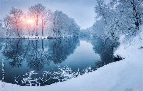 Winter forest on the river at sunset. Colorful landscape with snowy ...