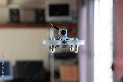 Micro spy drone flying inside a house. Remote controlled nano air ...