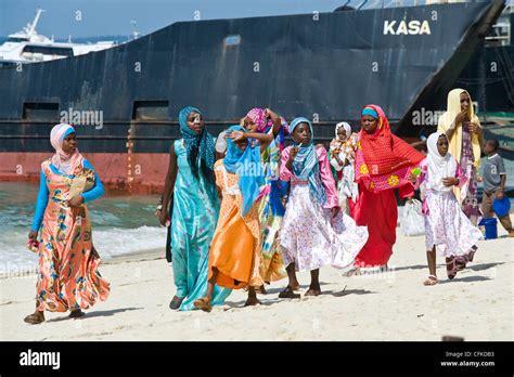 Swahili women in traditional dresses walking on the beach in Stone Stock Photo: 44068167 - Alamy