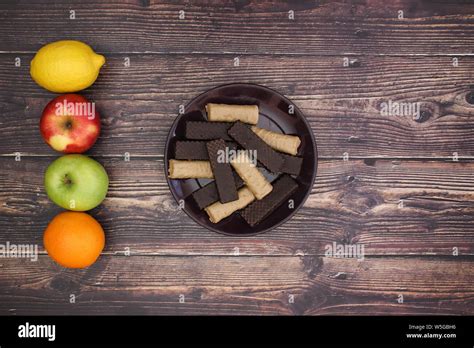 Fruits and healthy lifestyle vs cookies Stock Photo - Alamy