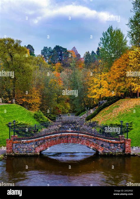 Ancient bridge in front of fall colored trees at Belmontas park in Vilnius, Lithuania Stock ...