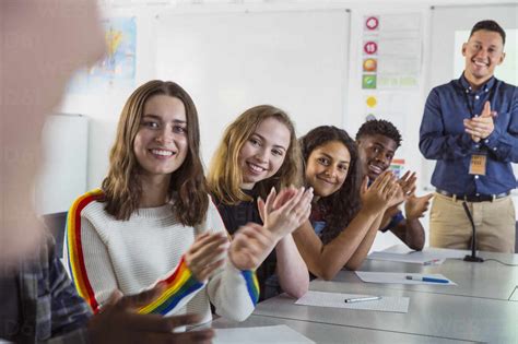 Happy high school students clapping in debate class stock photo