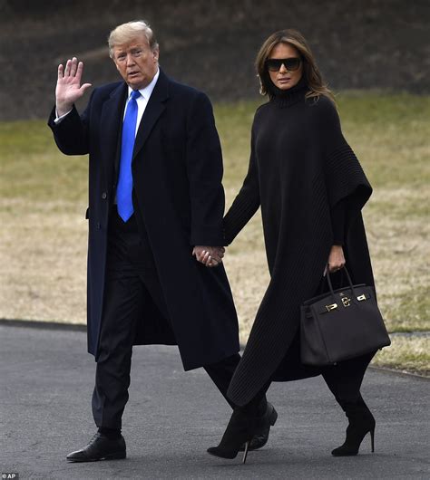 Melania Trump wraps up warm in a $2300 cape and holds hands with Donald ...