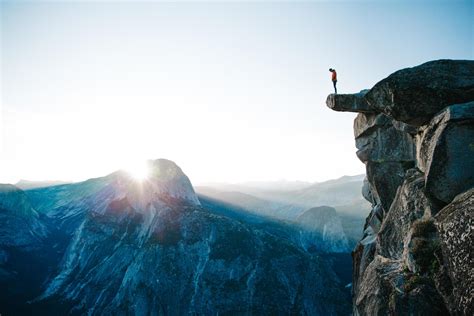 Man standing on cliff at Glacier Point 1237519 Stock Photo at Vecteezy