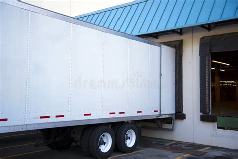 Semi Trailer Unloading Cargo In Dock Warehouse With Door Open Stock ...