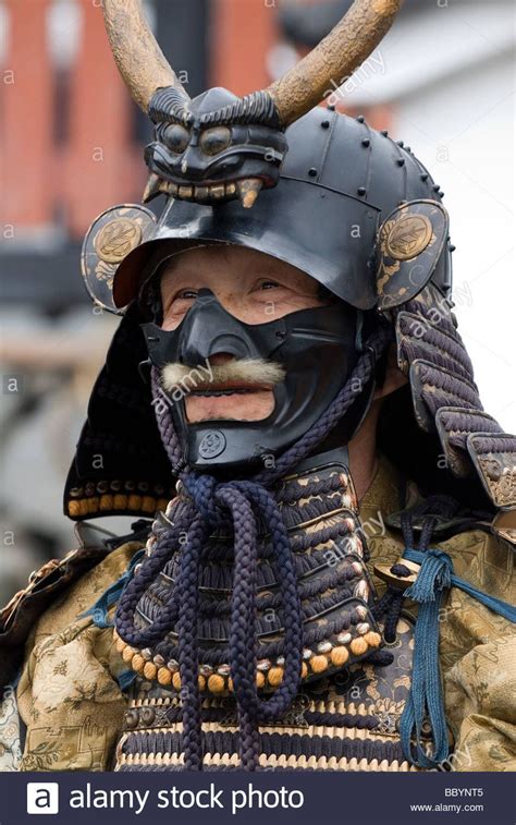 Man dressed in full samurai armor complete with kabuto helmet and mempo face mask to intimidate ...