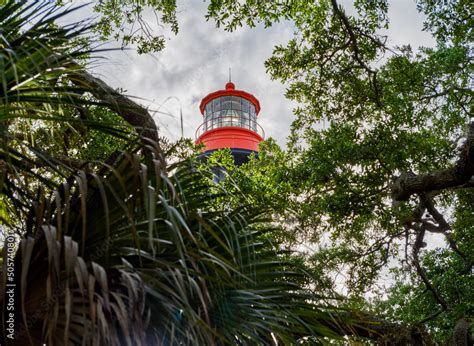 the colorful St Augustine Lighthouse on Anastasia Island in Florida viewed through the spanish ...