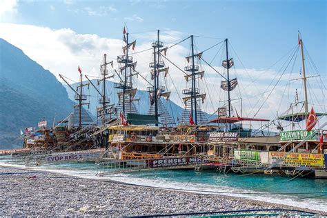 there are many boats that are docked in the water near each other on the beach