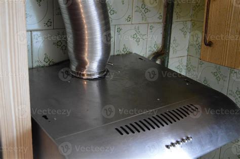 Installing a kitchen hood for ventilation 8881237 Stock Photo at Vecteezy