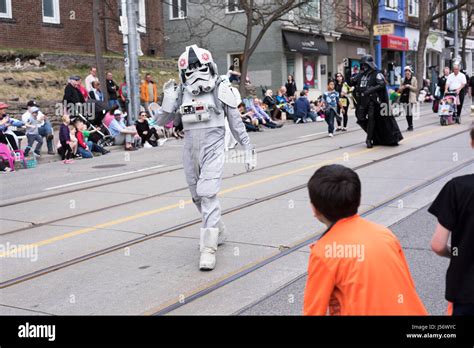 the Star Wars character Stormtrooper Pilot waves to children along the ...