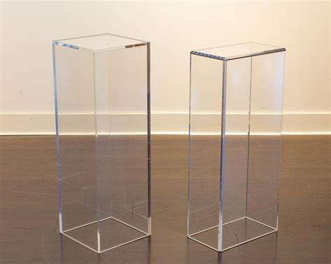 Lot - Two acrylic plinths. 34 5/8 x 15 1/2 x 9 in. (87.9 x 39.3 x 22.8 cm); 36 x 12 x 12 in. (91 ...