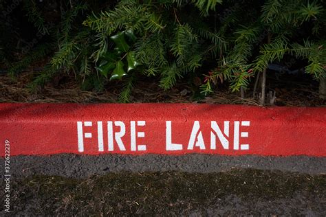 Painted fire lane curb markings. Stock Photo | Adobe Stock